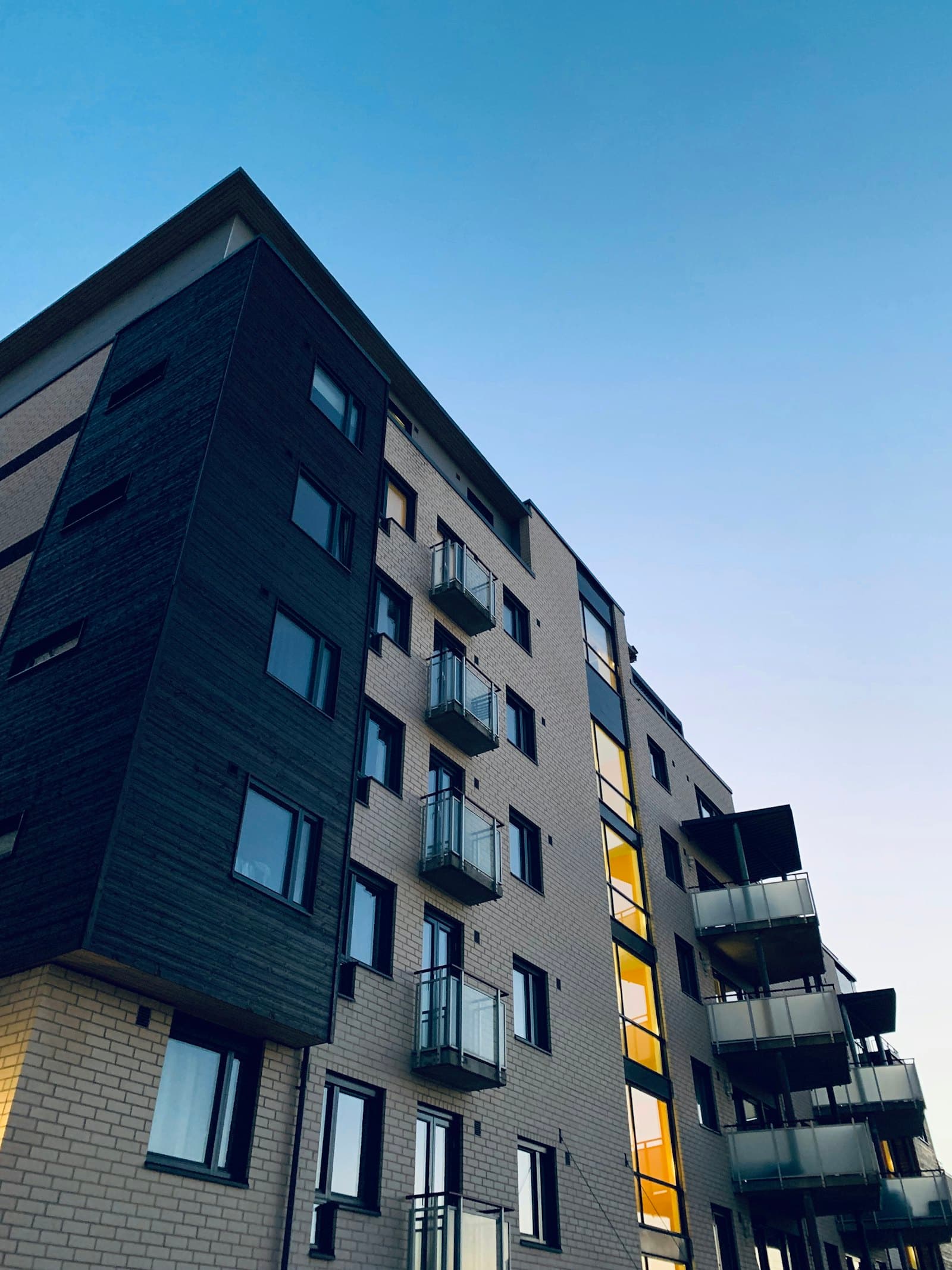 Mid-rise apartments at dusk · illustrative